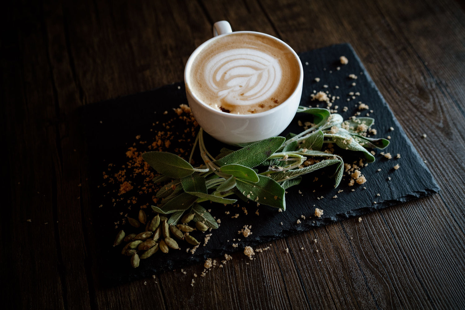 Smooth cup of coffee with latte art and herbs representing classic coffee roasts online collection